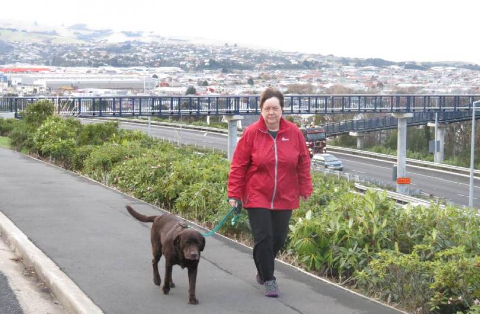 Lesley McTainish takes her dog Buster for a walk in Caversham - an activity she struggled with...