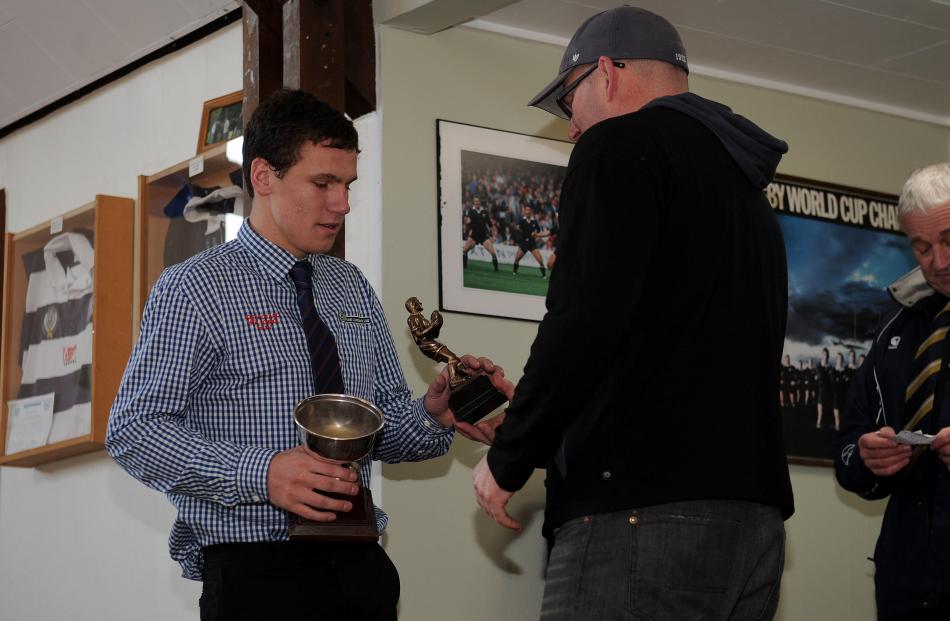 Dylan Greer captain of South Otago 1st XV receives a trophy from  Russell Lundy of Southern Wide...