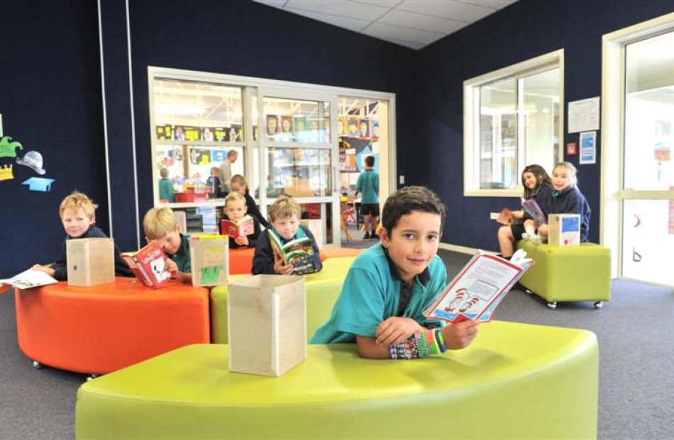 East Taieri School pupil Luke Marsden (8, front) reads a book in the school's new learning hub,...