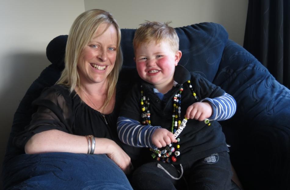 Rebecca Michelle and son Xavier (2), wearing his 'Beads of Courage', relax at home in Mosgiel....