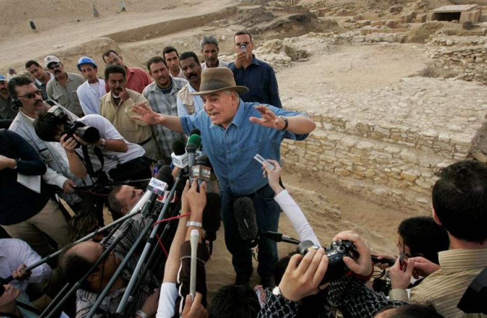 Egypt's antiquities chief Zahi Hawass, centre, speaks to the media at the site of a newly...