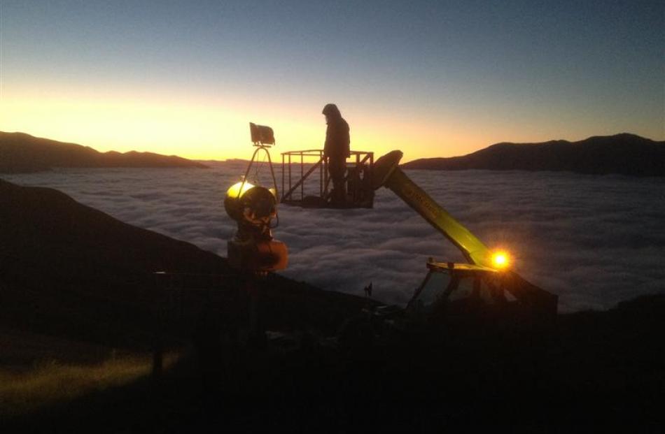 Electrician Wesley Sayer, of Queenstown, does some early morning testing of the new  metal halide...