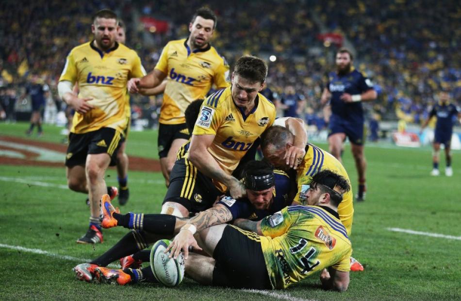 Elliot Dixon of the Highlanders dives over to score a try during the Super Rugby Final match...
