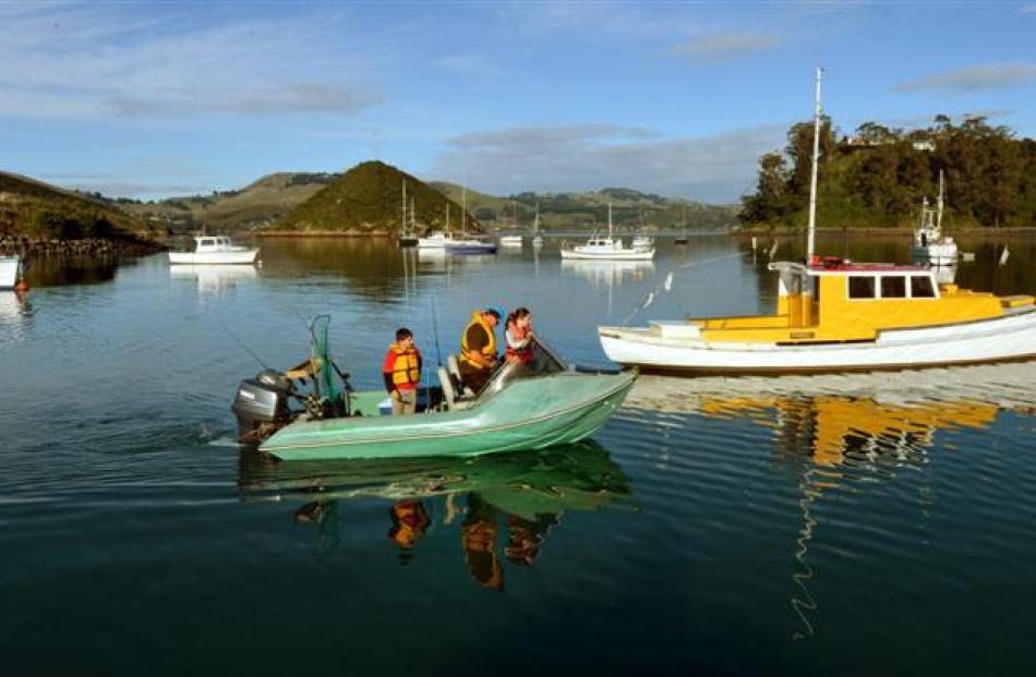 Embarking on a fishing trip from Back Beach in Dunedin yesterday are (from left) Hayden (10),...