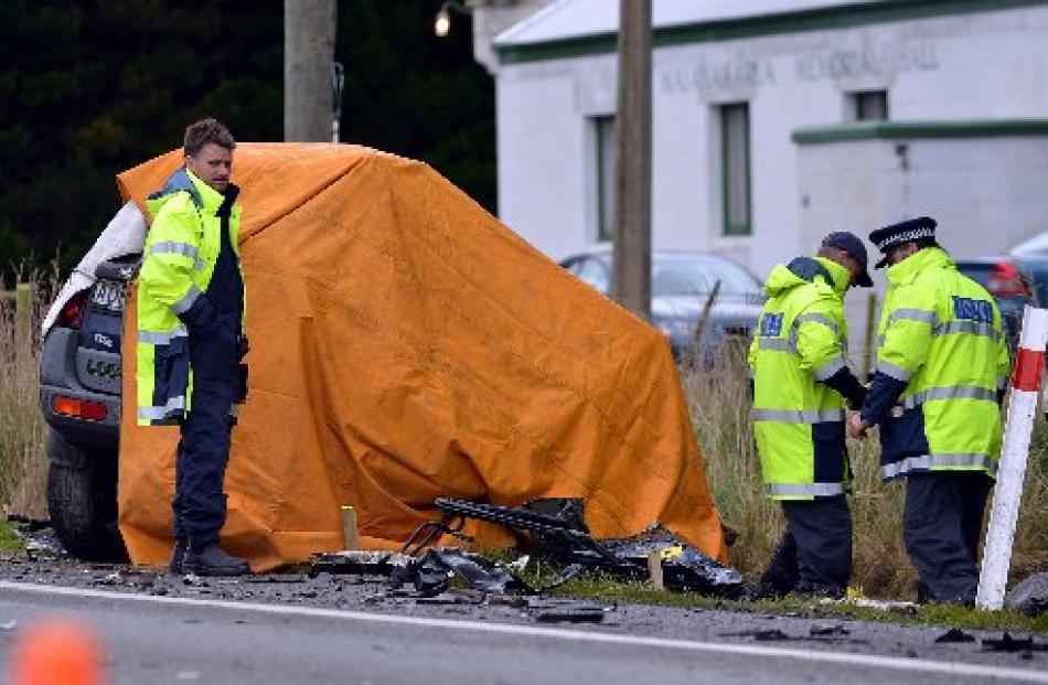 Emergency services personnel and police attend the scene of a fatal collision between a truck and...
