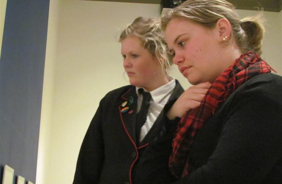 Emma Smith (17, left) and Hannah Stevenson (18) assess the artistic merits of artworks on display...