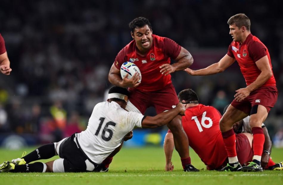 England's Billy Vunipola crashes through the Fiji defence on his way to the tryline. Photo Reuters