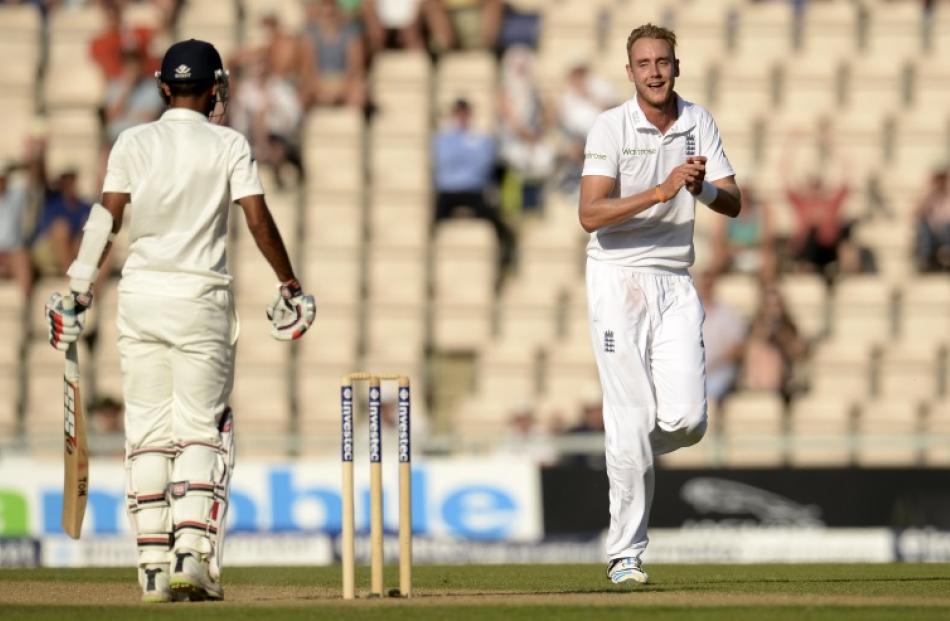 England's Broad celebrates after the dismissal of India's Kumar during the third cricket test...