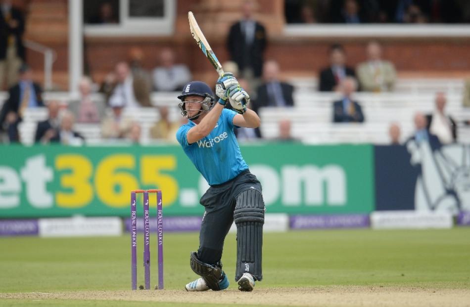 England's Jos Buttler hits a six during the fourth one-day international cricket match against...