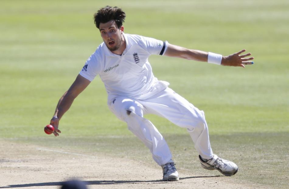 England's Steven Finn fields from his own bowling during the second cricket test match against...