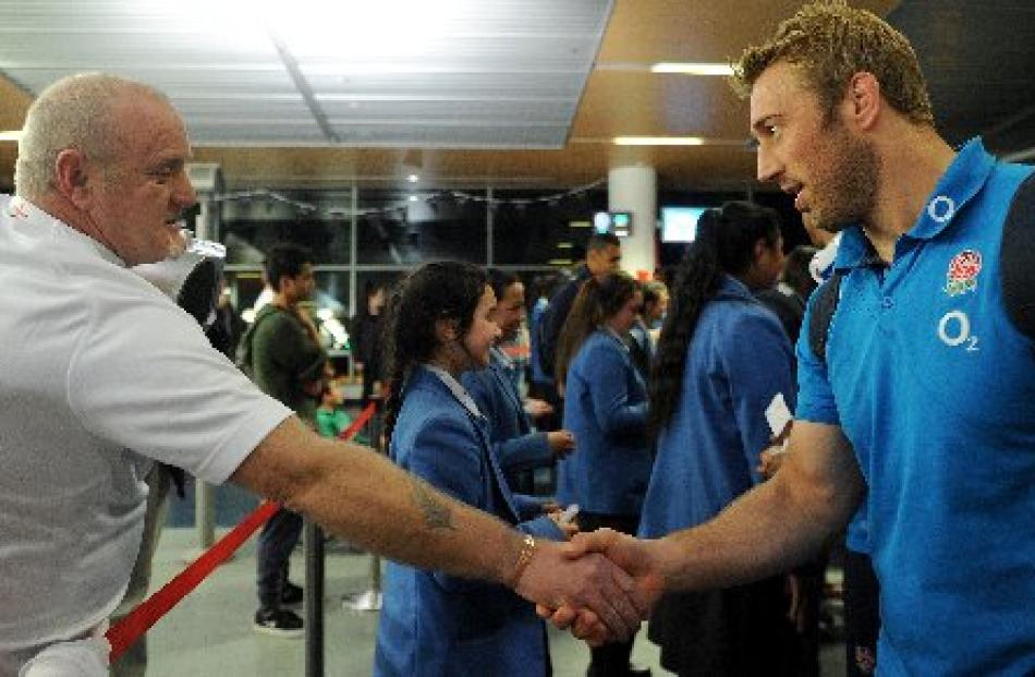 England supporter Adam Morton sen, of Dunedin, shakes hands with England captain Chris Robshaw at...