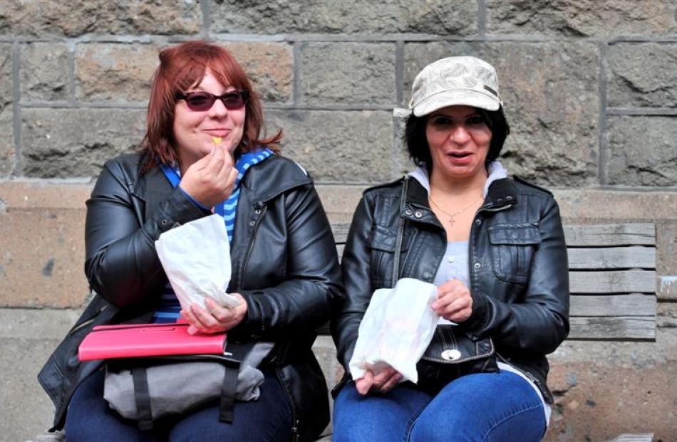 Enjoying some chips outside the Dunedin Law Courts yesterday are Pacific Pearl passengers Jackie...