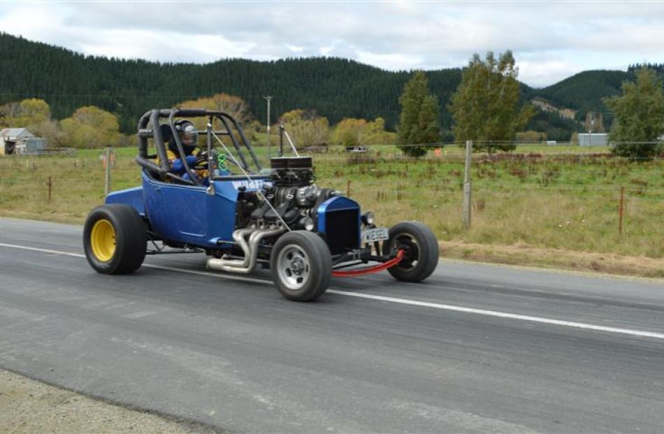 Eric Eaves, of Gore, charges down the Wetherstons straight in his Ford T Bucket at the Lawrence...