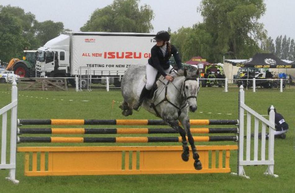 Erin Milner, of Dunedin, on Glenbrooke Jordie Girl, competes in the showjumping event.