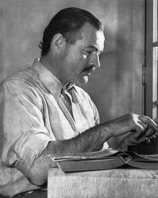 Ernest Hemingway posing for a dust jacket photo for the first edition of For Whom the Bell Tolls...