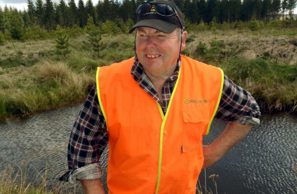 Ernslaw One Naseby forest manager Greg Kendall beside a koura pond in the forest. Photos by...