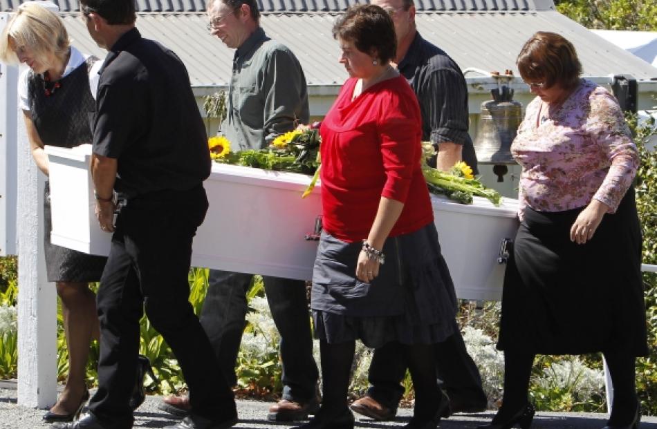 Family members carry the casket of Christchurch earthquake victim Shane Tomlin at the funeral...