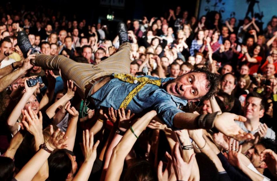 Fans carry English musician Charlie Winston through the audience during his concert in Hamburg,...