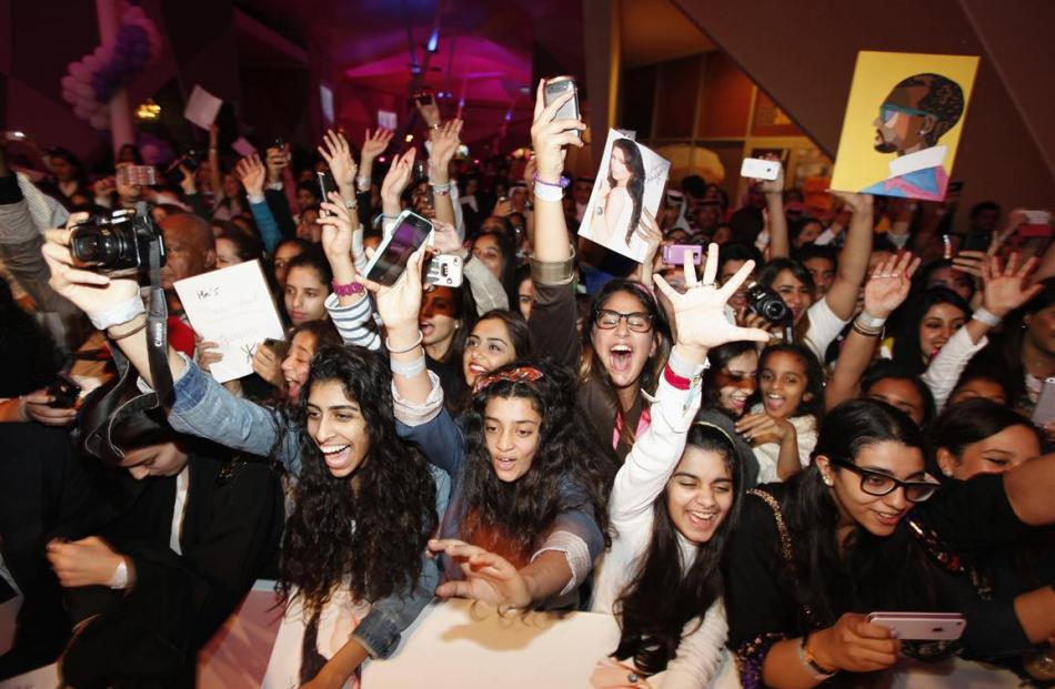 Fans cheer as US television celebrity Kim Kardashian performs during a promotional visit to a...