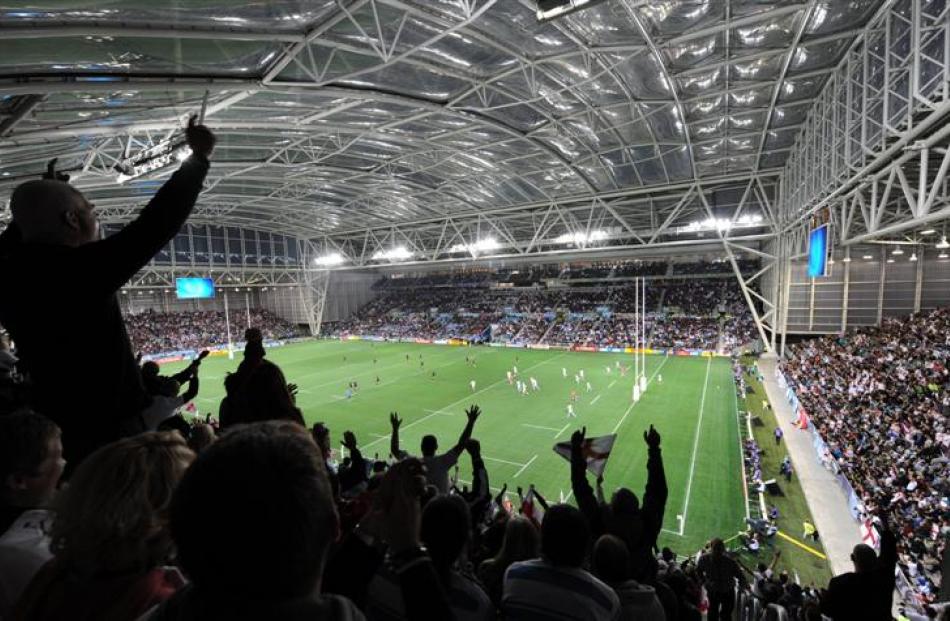 Fans cheer on England and Argentina at a packed Otago Stadium on Saturday night. Photo by Stephen...