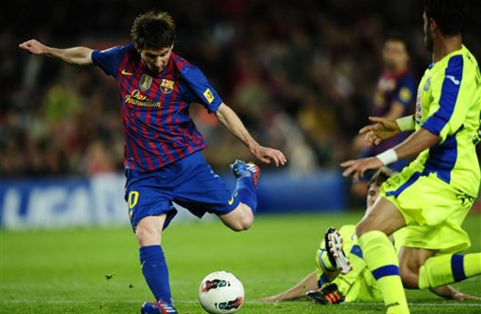 FC Barcelona's Lionel Messi shoots to score against Getafe during a Spanish La Liga match at the...