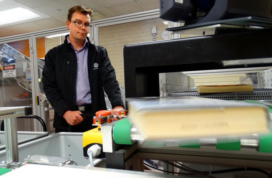 FE Technologies director Clint Agustsson tests the new sorting machine installed at the Dunedin...