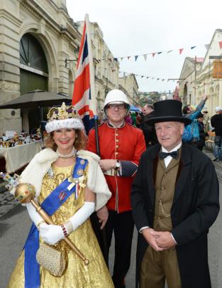 Julie Walker, Chris Jones and Marcus Brown take a regal stroll down Harbour St.