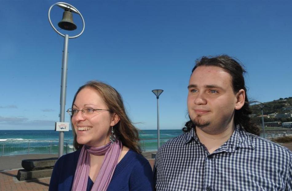 Film-makers Nicole Schafer and Andrew Scott stand beside the St Clair Beach shark bell. Photo by...
