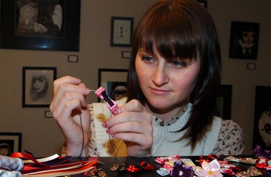 Fiona Johnston hand-stitches one of her hair clips at her Dunedin studio. Photo by Jane Dawber.