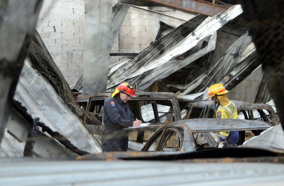 Fire risk management officers Stuart Ide (left) and Cathy Trevathan inspects the fire damage at...