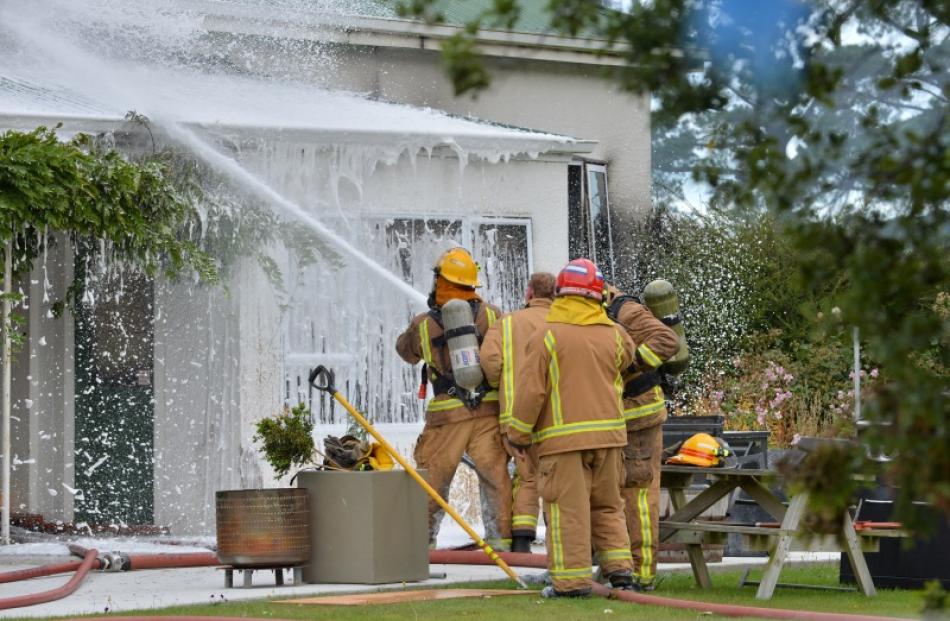 Firefighters battle the blaze. Photo: Gerard O'Brien