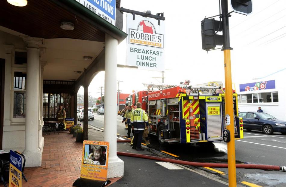 Firefighters outside the Macandrew Rd pub. Photos by Linda Robertson.