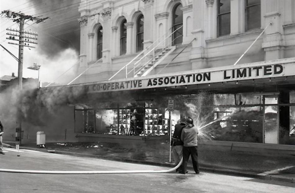 Firefighters tackle the 1969 Farmers Co-operative department store fire in Oamaru. Photo supplied.