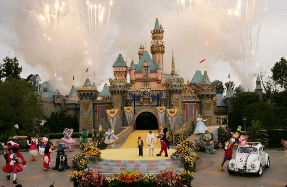 Fireworks explode in front of Sleeping Beauty Castle during the 50th anniversary of Disneyland in...