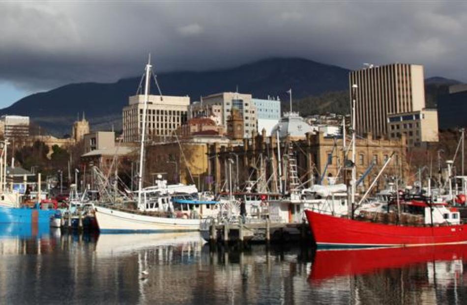 Fishing boats and pleasure craft are moored at Constitution Dock in Hobart. Flanked by both...