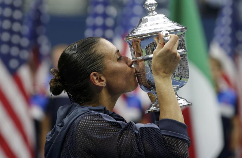 Flavia Pennetta of Italy kisses her U.S. Open Trophy after defeating compatriot Roberta Vinci in...