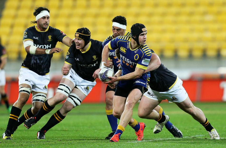 Fletcher Smith of Otago looks to offload during the ITM Cup semifinal between Wellington and...
