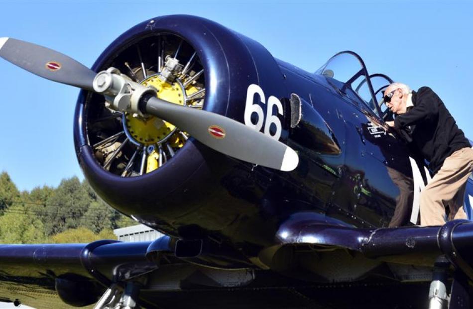 Former Harvard pilot George Hurst inspects a 1943 Harvard aircraft in Mosgiel. Photo by Peter...
