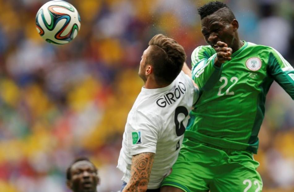 France's Olivier Giroud (L) fights for the ball with Nigeria's Kenneth Omeruo. REUTERS/Ueslei...