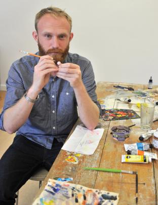 Frances Hodgkins fellow 2014 Patrick Lundberg paints pins for one of his works. Photos by Linda...