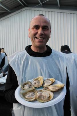 Frank Dean serves oysters au naturel to help raise funds for the Awarua Boating Club.