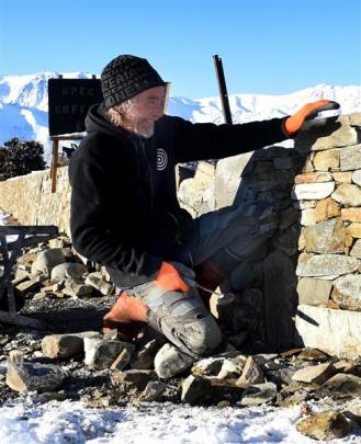 Frank Naughton repairs a stone wall outside The Wrinkly Rams cafe at Omarama. Photos by Peter...