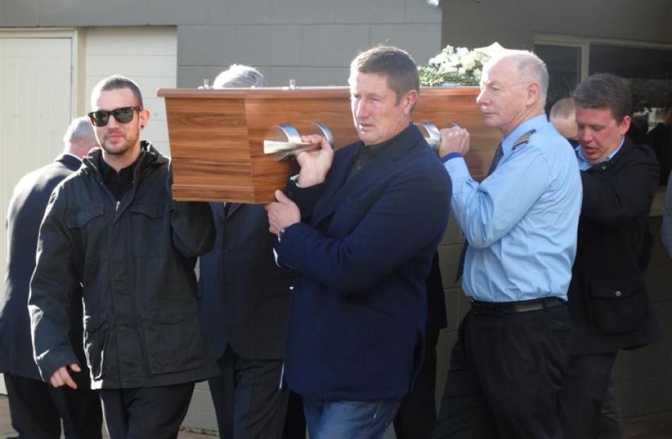 Friends and family carry the casket of Glenorchy Air senior pilot Ray Crow after a funeral...
