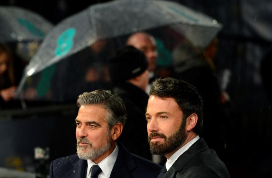 George Clooney (L) and Ben Affleck pose as they arrive for the Bafta awards ceremony at the Royal...