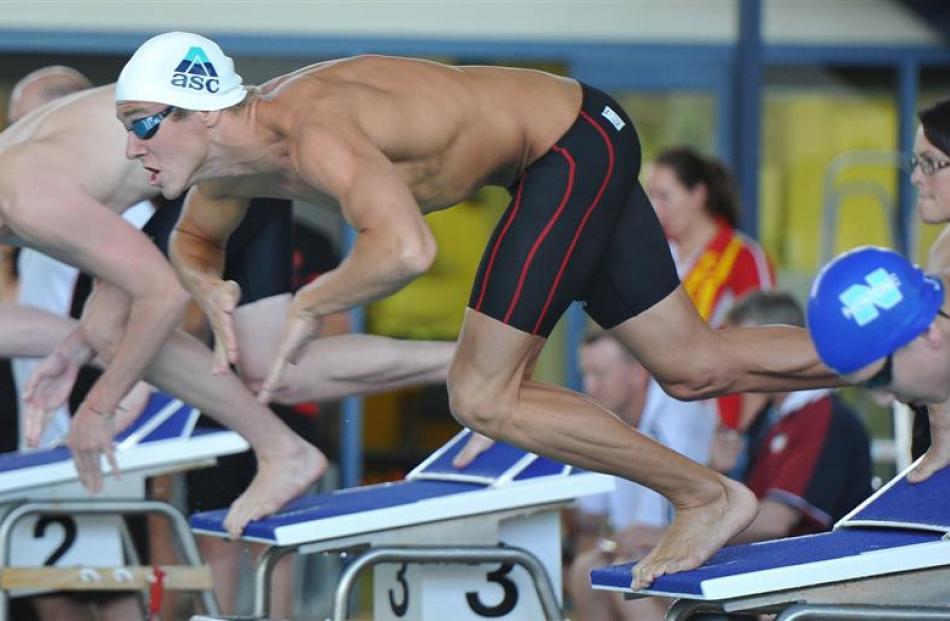 George Schroder (Aquagym) dives into the water at the start of the  men's open 100m breaststroke...