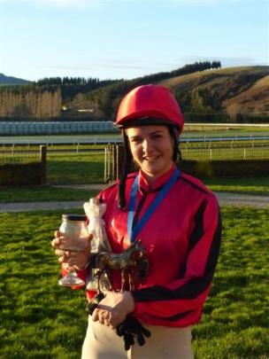 Georgia Sumner-Davis with her spoils after winning the Charity Riders Oaks at Wingatui on Sunday....