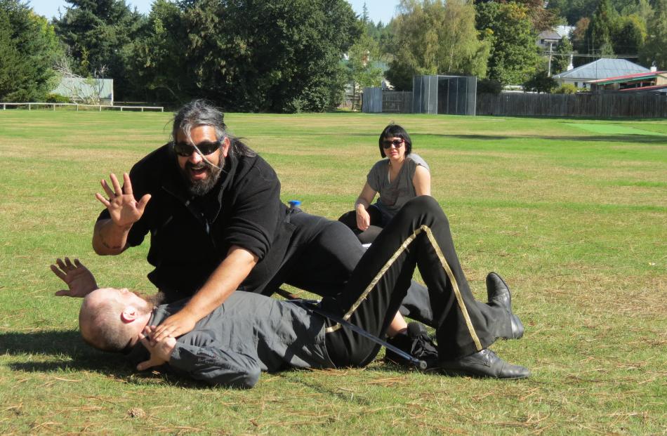 Getting down . . . Auckland Medieval Battle Arts Association captain James Bennett topples Arne...