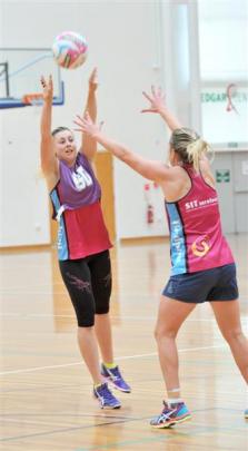 Gina Crampton throws a pass over Stacey Peeters at the Edgar Centre on Thursday. Photo by Linda...