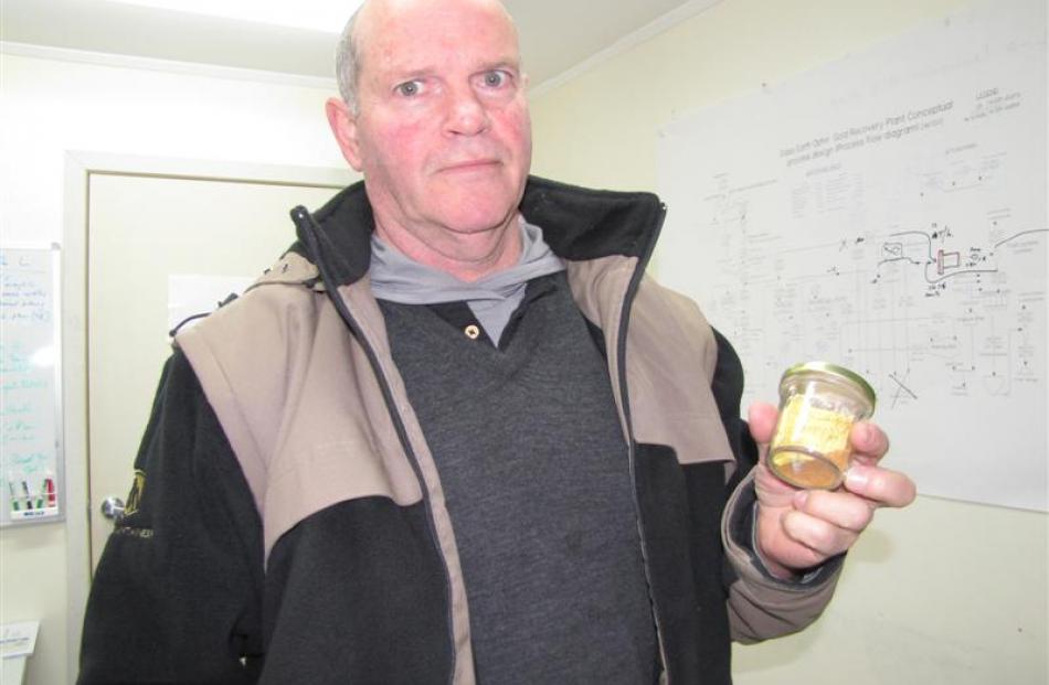 Glass Earth Gold president and chief executive officer Simon Henderson with a 3.4ounces of gold...