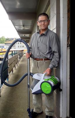 Glenross Apartments tenant Stephen Hughes holds a vacuum cleaner he bought from a Home Direct...